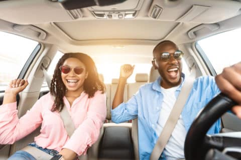 happy couple with greater financial freedom after refinancing a car loan