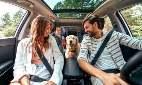 happy family on road trip after refinancing a car loan